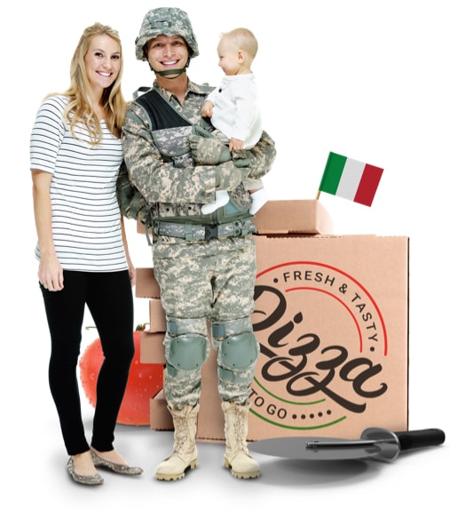 Soldier holding child with wife. Pizza boxes are stacked behind them.